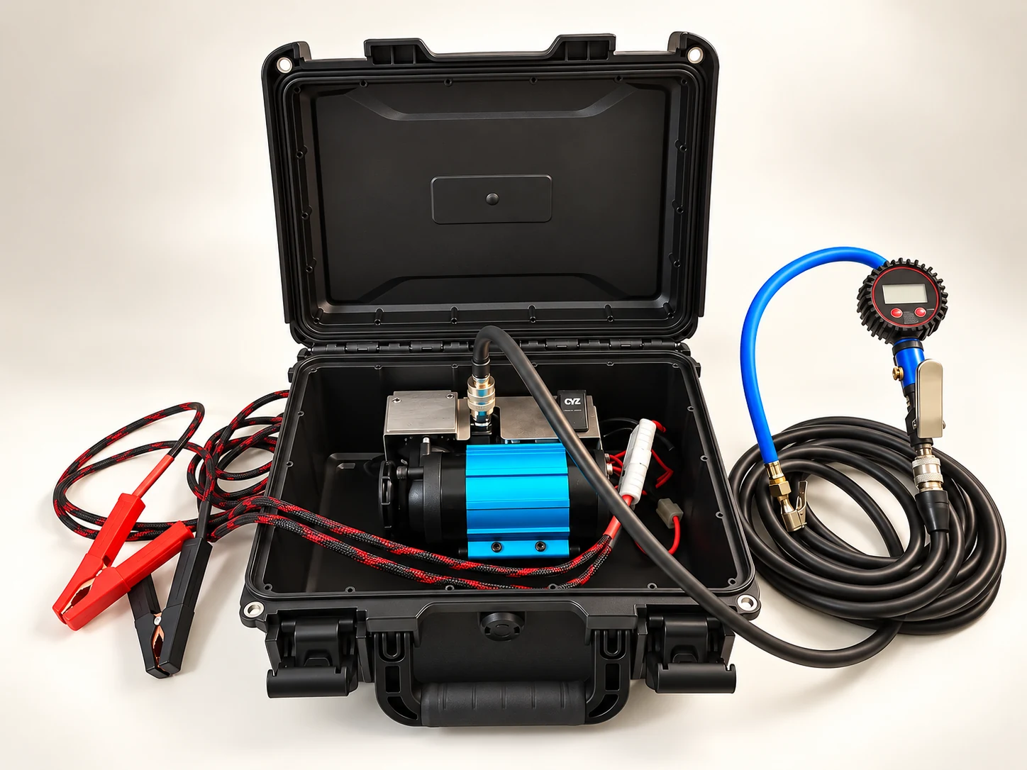 Portable compressor kit with hose and power leads unpacked